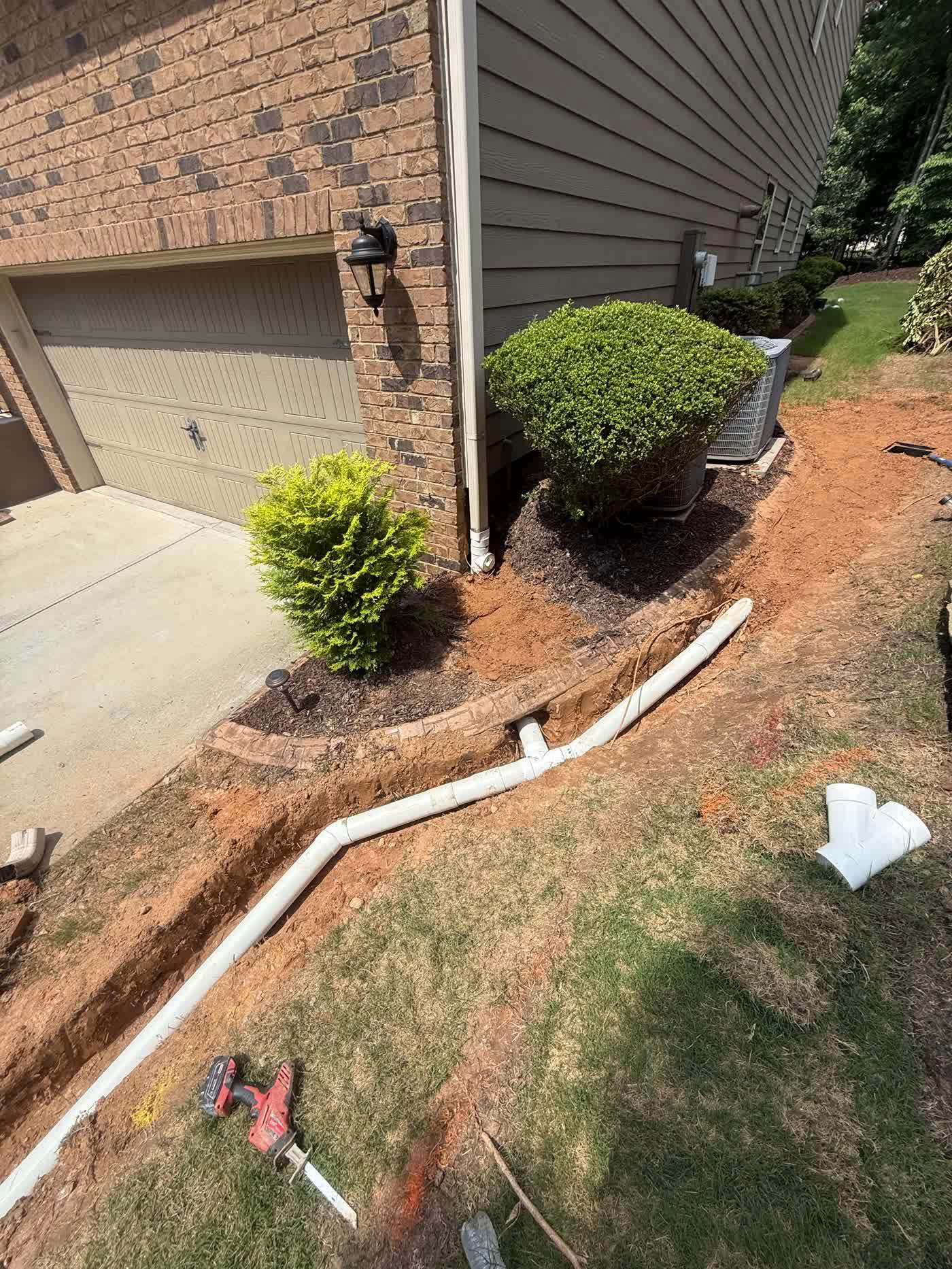 Buried drain line run out to daylight across a yard
