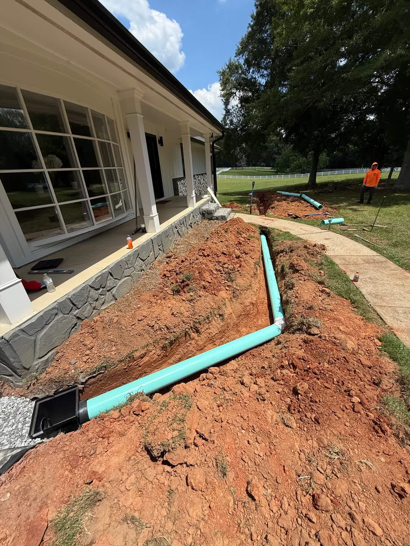 Drain line carried along the side of a house