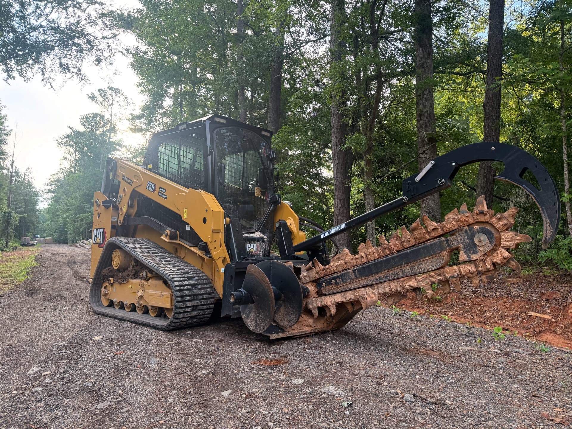 Tracked skid steer with forestry mulcher attachment