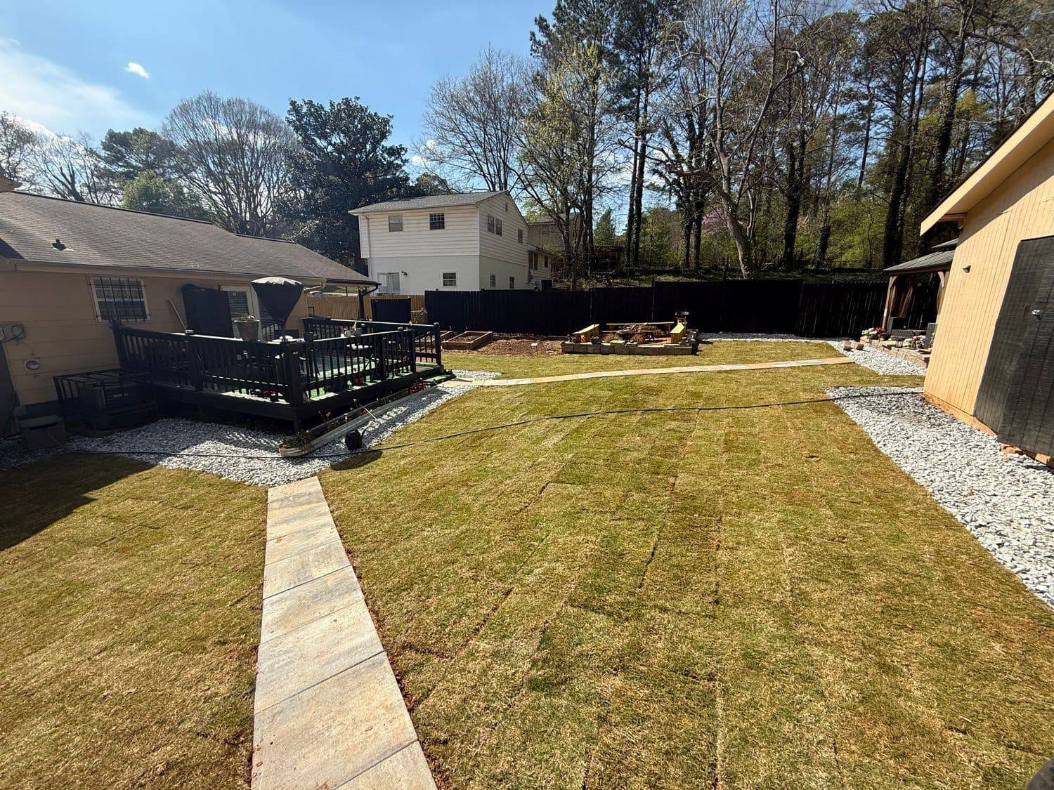 Finished backyard landscape with stone path and gazebo