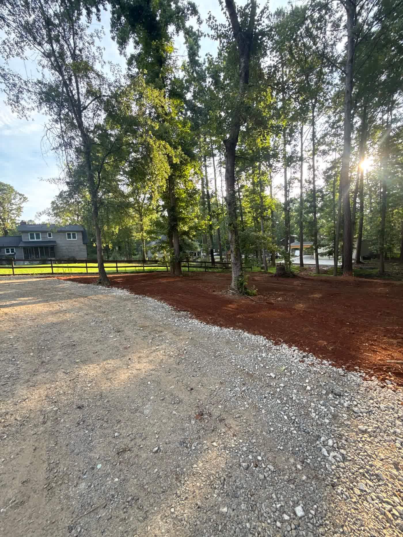 Graded drive cut running through a wooded lot