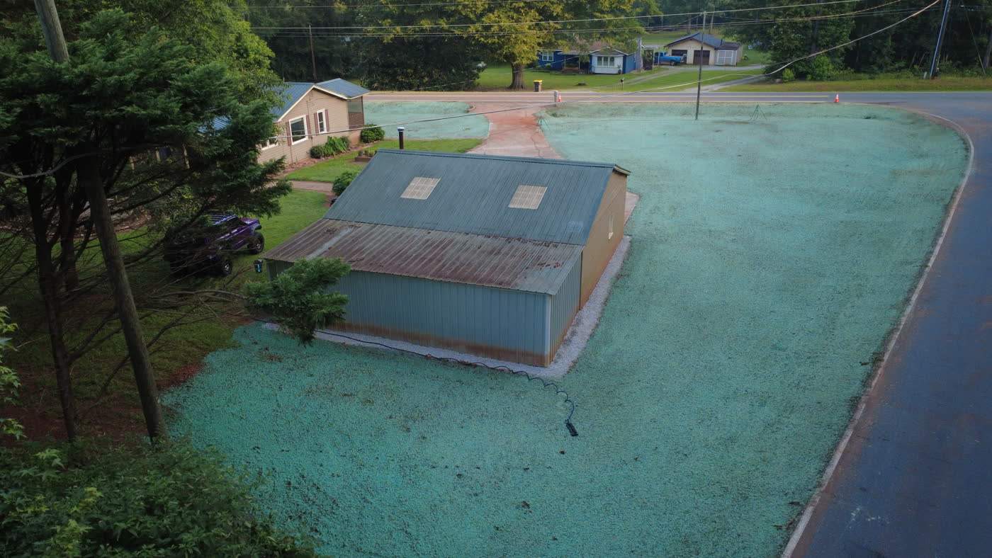 Aerial view of a commercial building ringed with fresh hydroseed