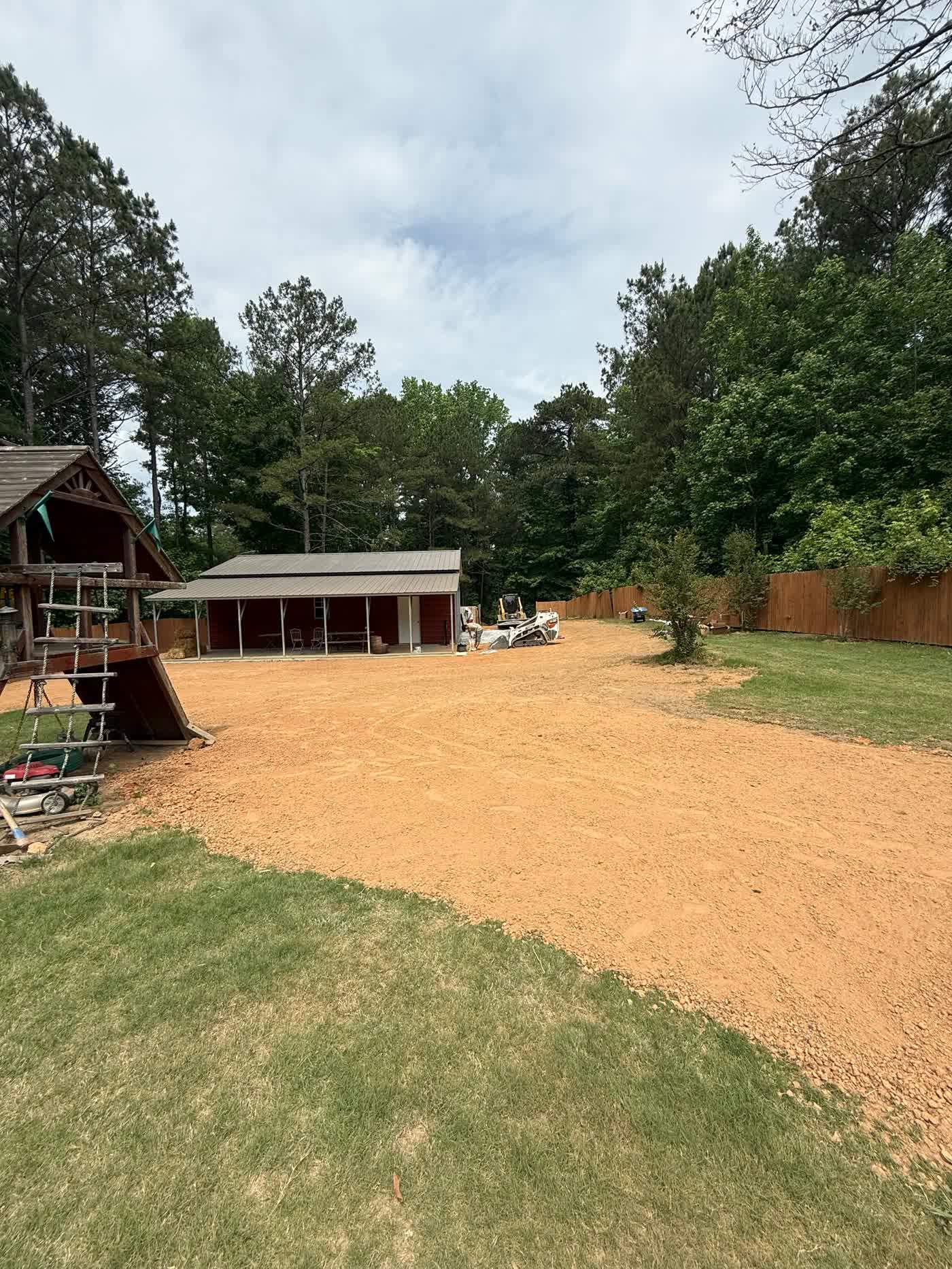 Hydroseeded lawn greening up beside a carport