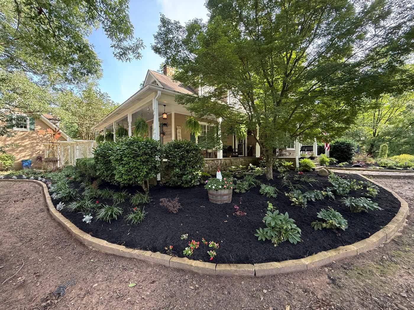Curved mulched bed with fresh shrubs and edging