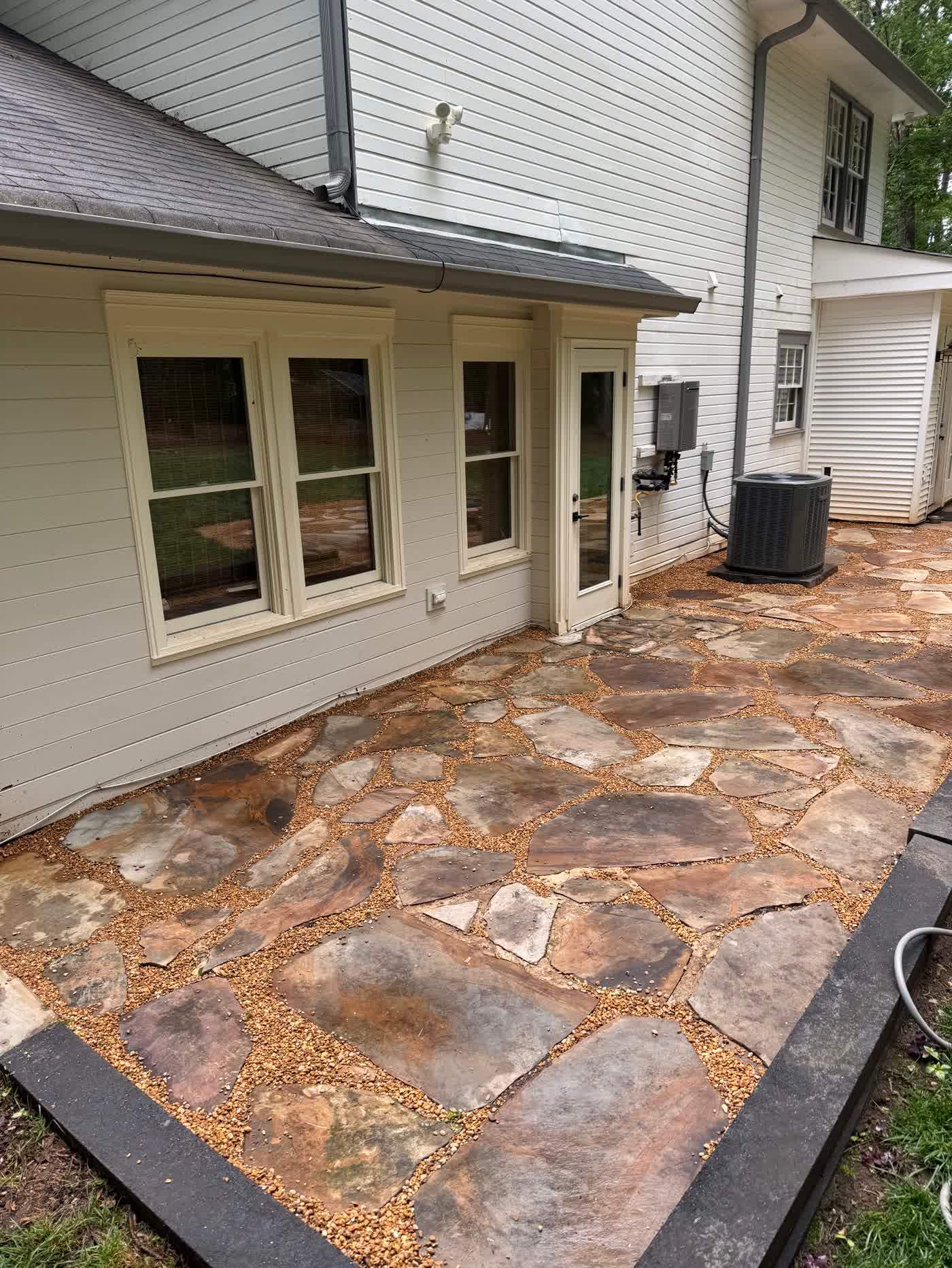 Flagstone patio laid at the back of a house