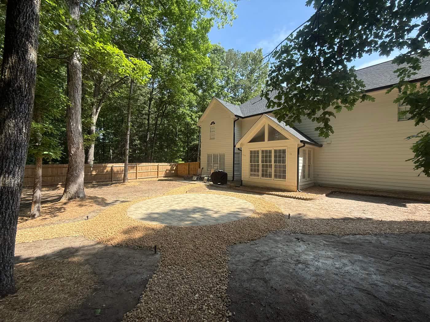 Gravel drive and graded grounds beside a home