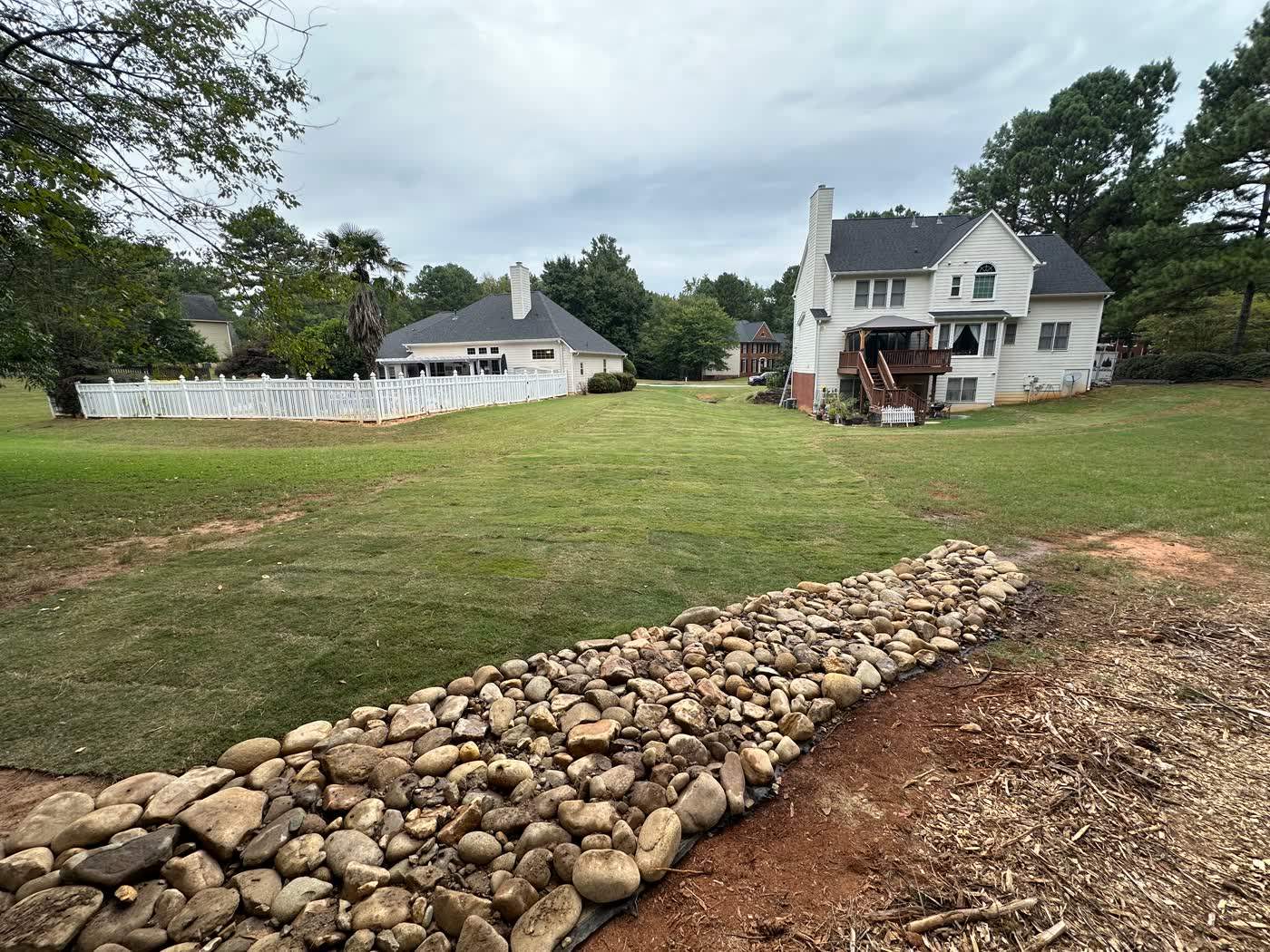 Fresh sod meeting a fieldstone retaining wall