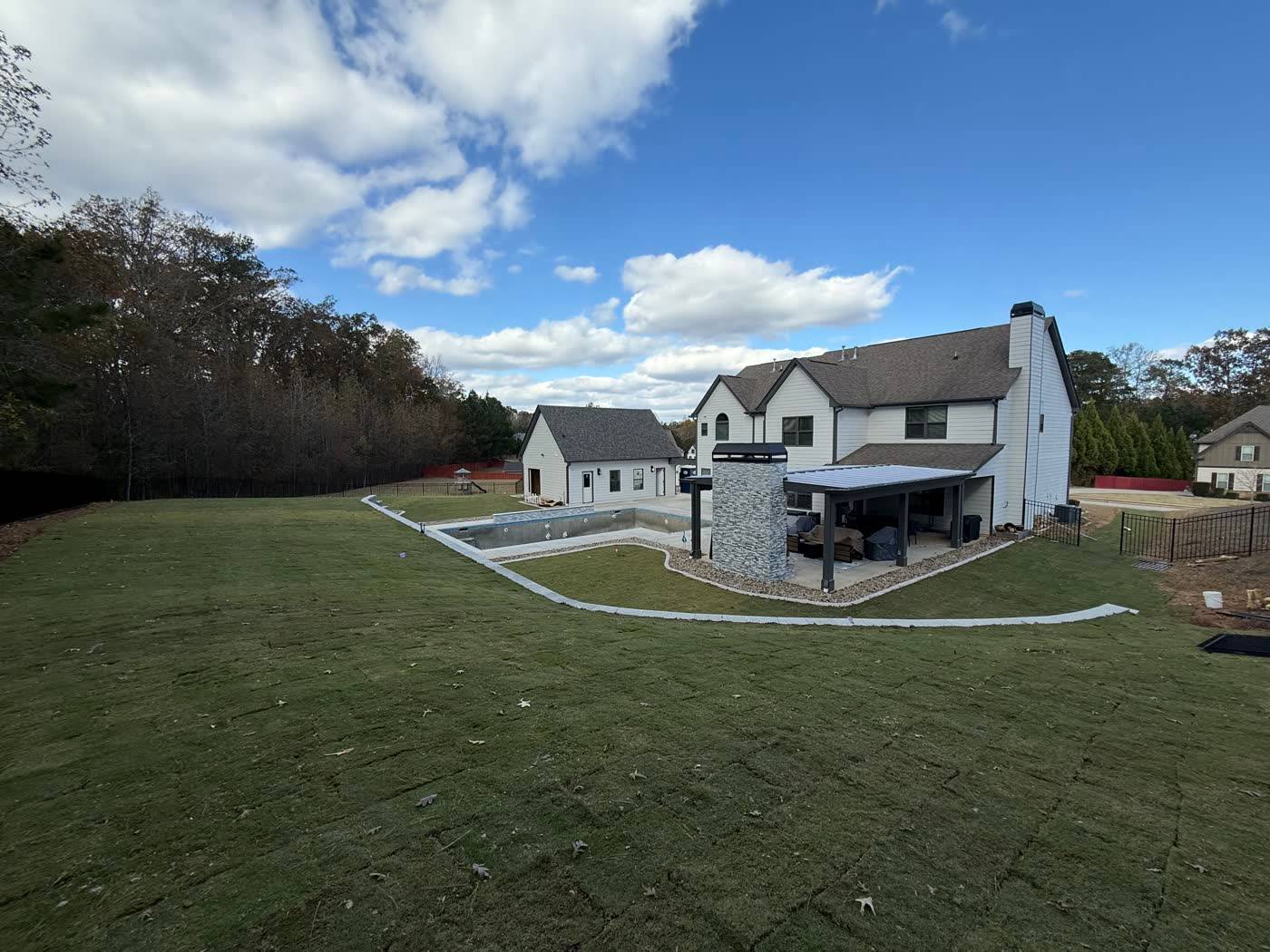 Wide finished sod lawn running back to the treeline