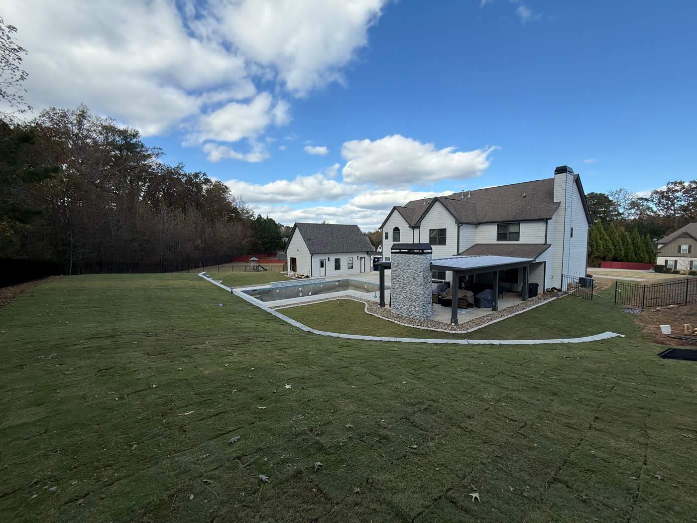 Wide finished sod lawn running back to the treeline