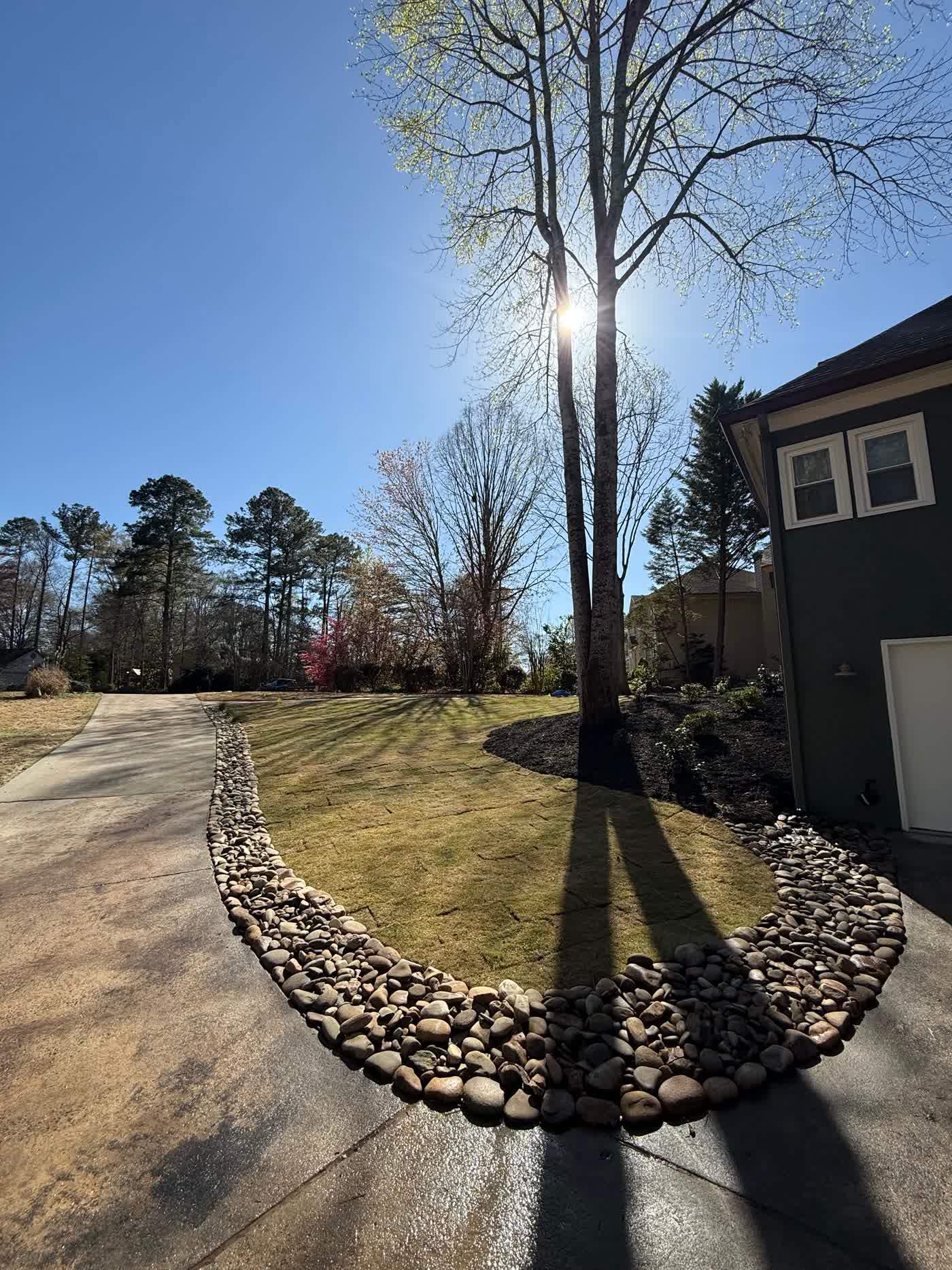 Fresh sod curving around a fieldstone wall