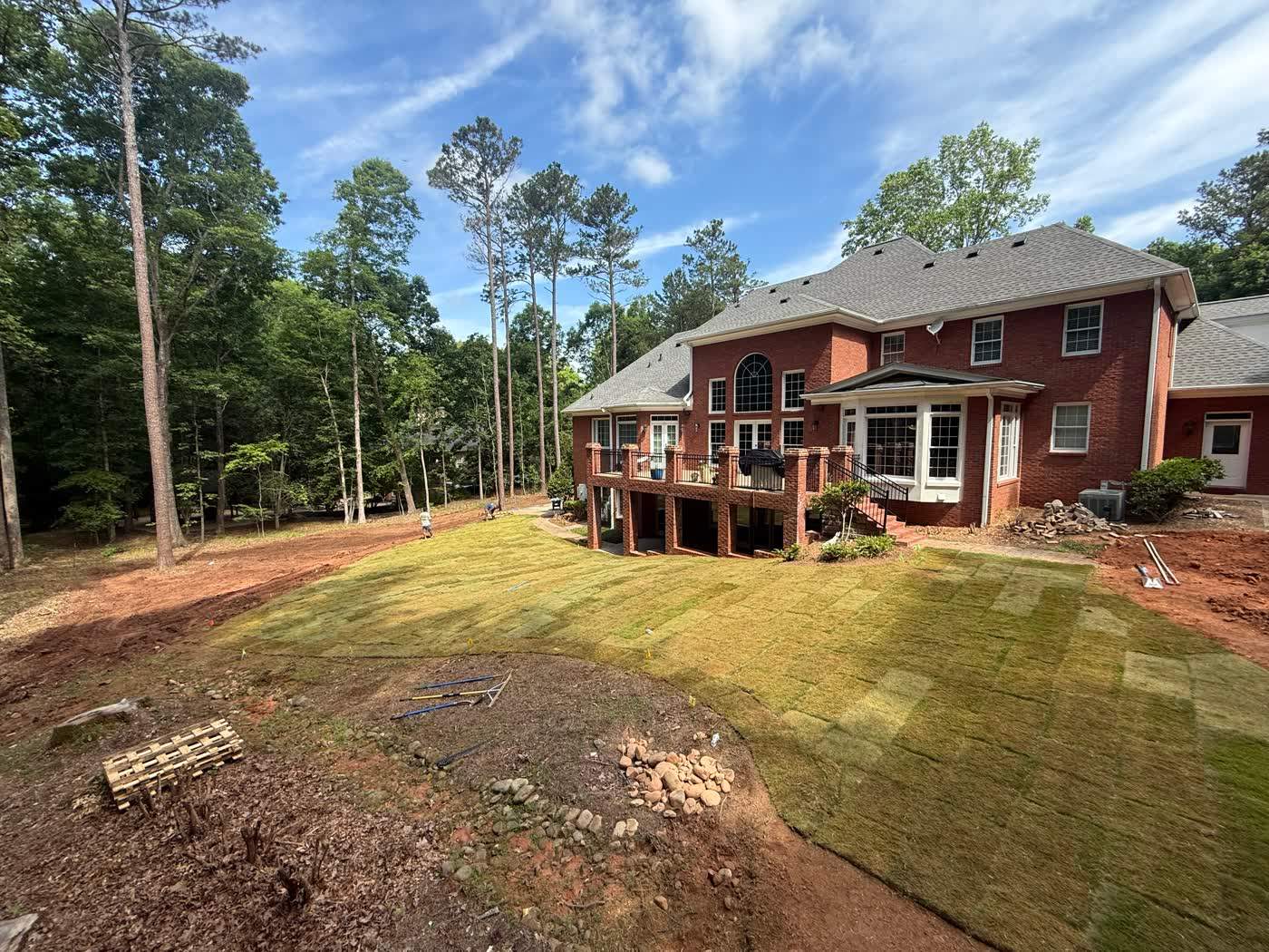 Freshly sodded front lawn at a brick home