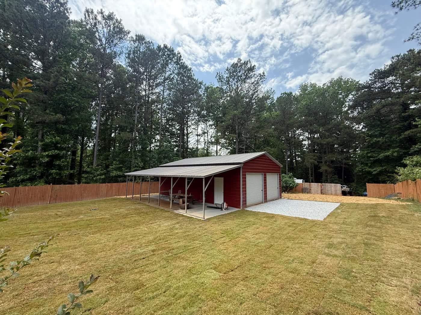 New sod lawn laid around a red barn