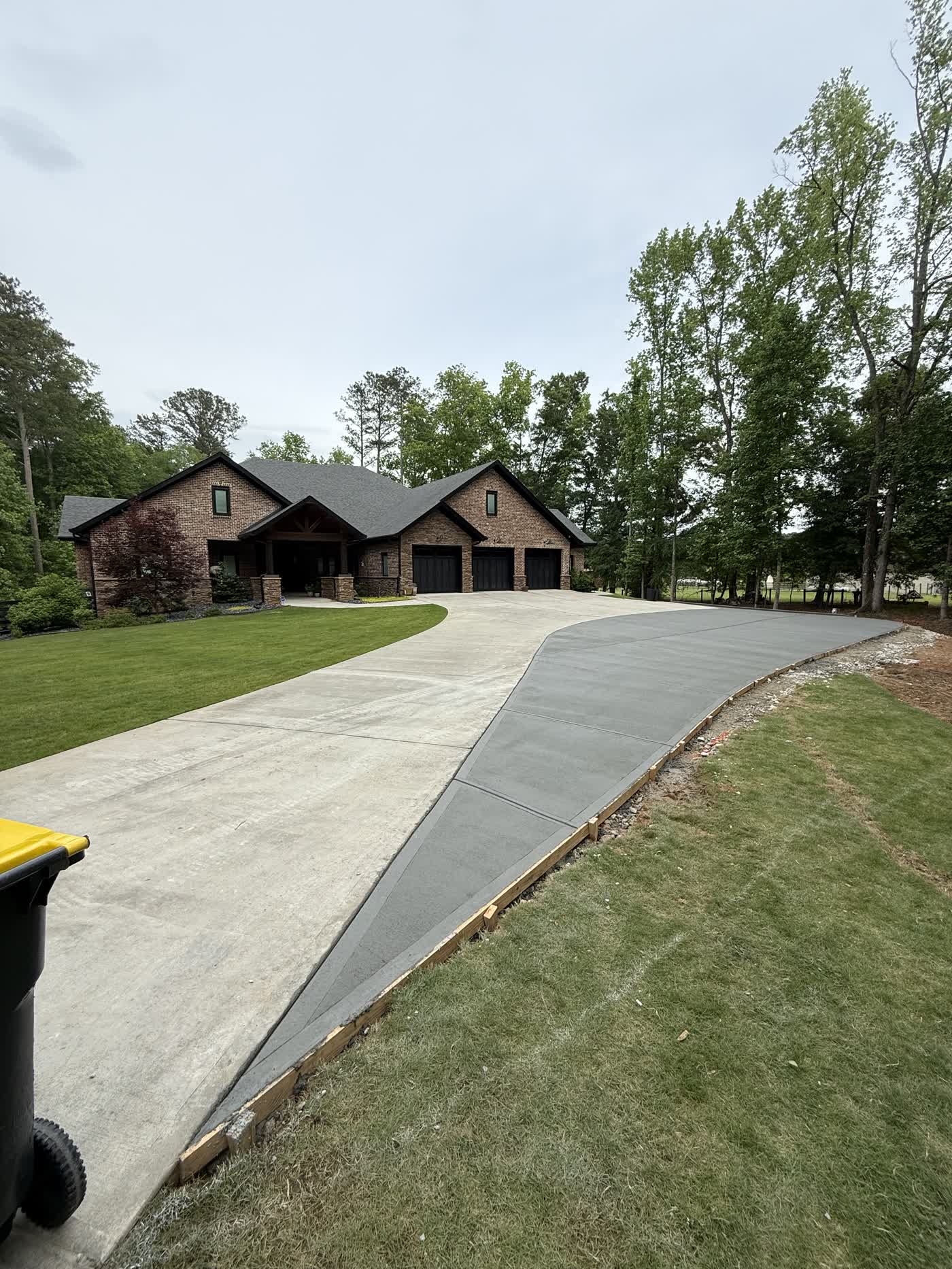 New concrete driveway leading up to a home