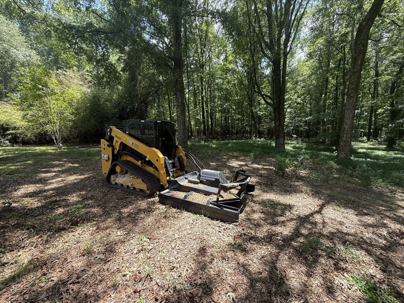 Forestry mulcher clearing wooded land