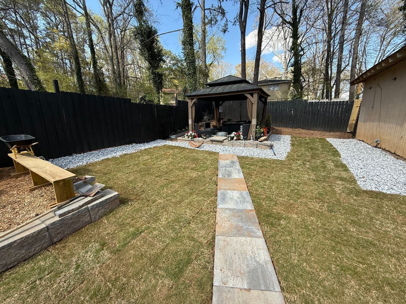 Finished backyard hardscape with stone walkway and gazebo